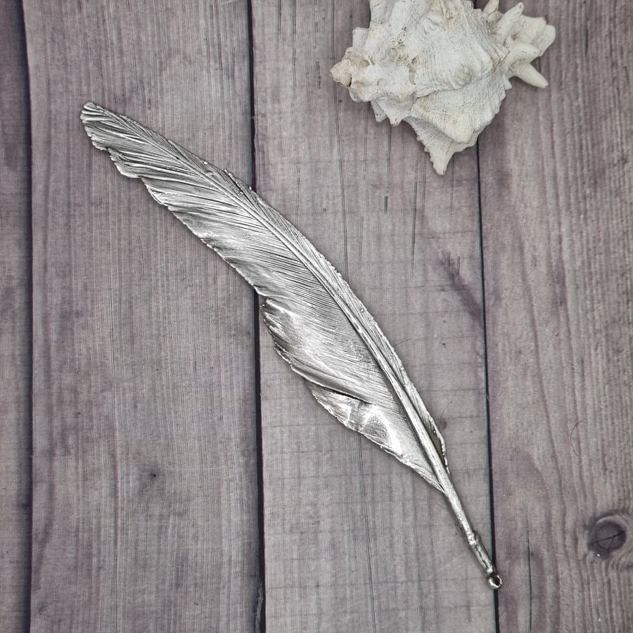 Real feather preserved in silver, beautiful ornament 