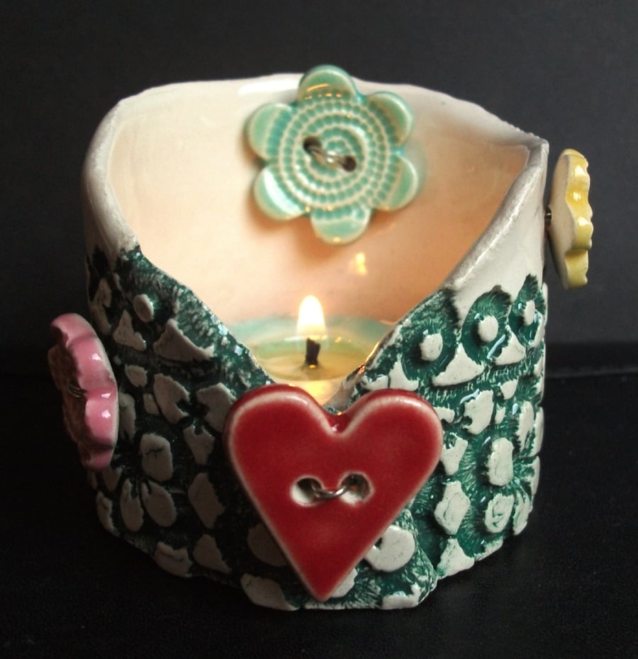 Ceramic tea light holder with heart and flower buttons