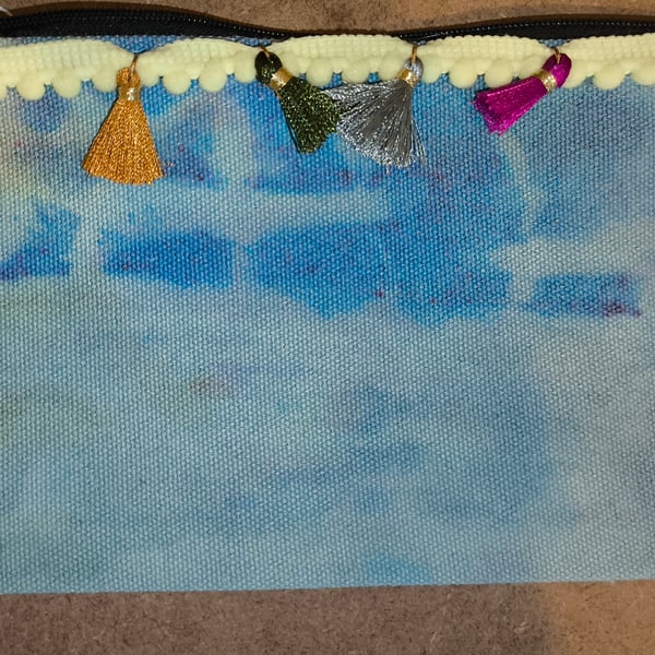 Small blue zipper pouch with spots of pink and yellow 