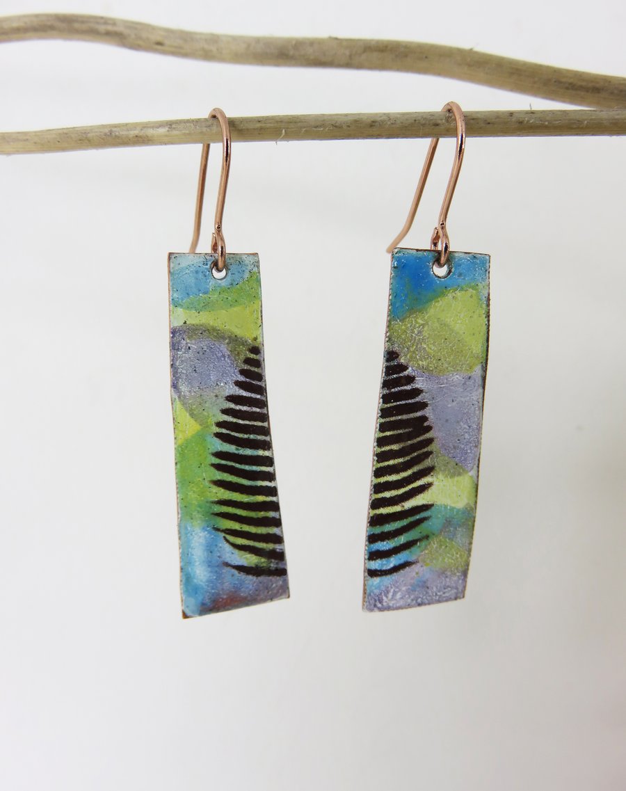 Dangle enamel on copper earrings with colour washes and leaf detail.