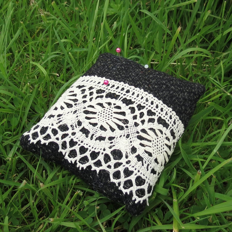 A pin cushion made from tactile wool and vintage lace.