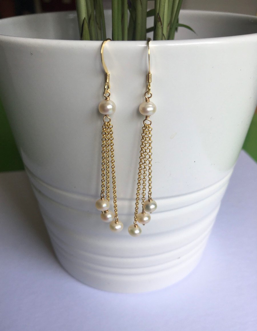 Long chain earrings with natural button pearls