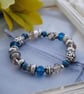 Silver and blue bead stretch bracelet - Image 1