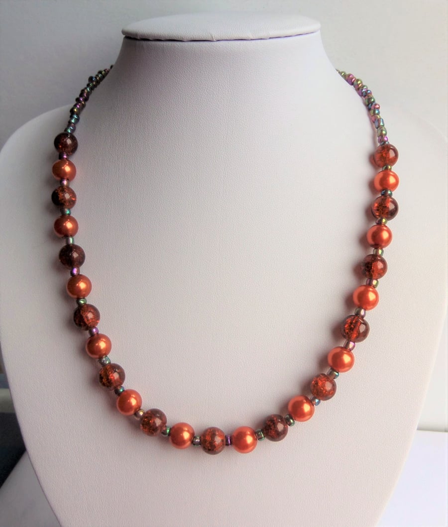 Orange glass bead and metallic rainbow seed bead necklace