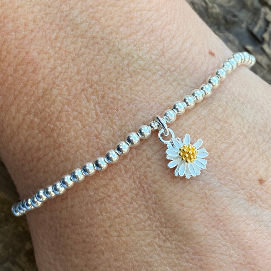 Sterling silver bead bracelet with daisy charm. Stretch bracelet. 