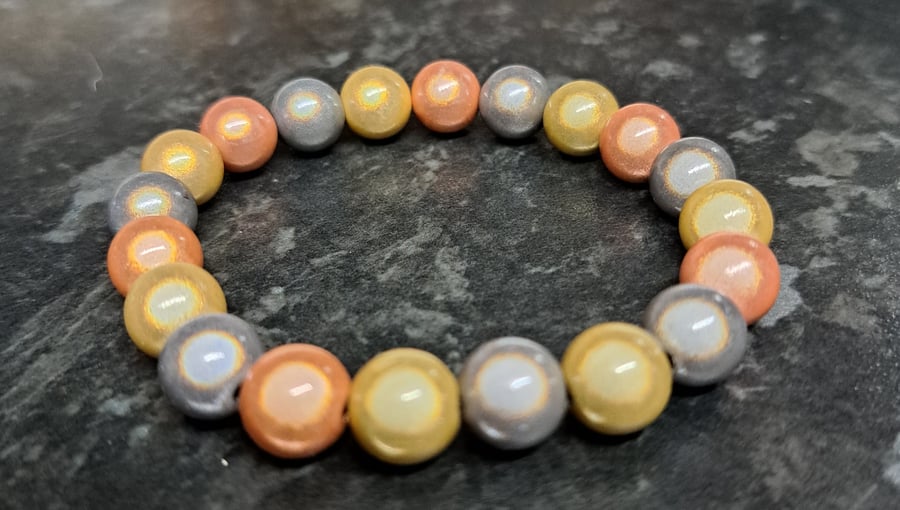 Lovley disco beaded elasticated bracelet. gold, rose gold and silver.Dazzle