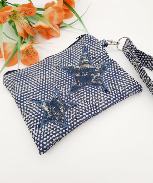 Blue star applique clutch bag with clip on handle. 