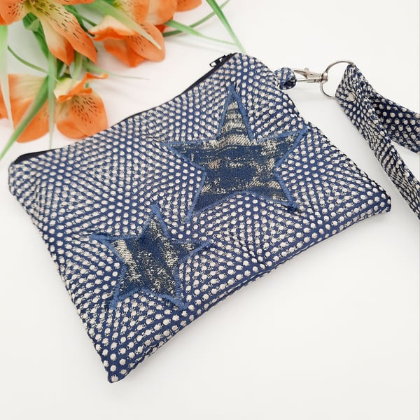 Blue star applique clutch bag with clip on handle. 