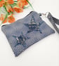 Blue star applique clutch bag with clip on handle. 
