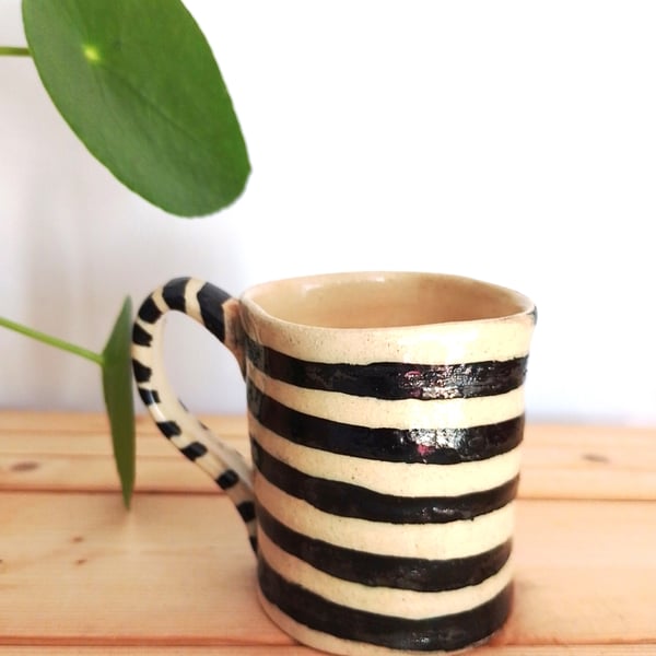 wonky stripey black and white ceramic mug, curiosity novelty pottery mug
