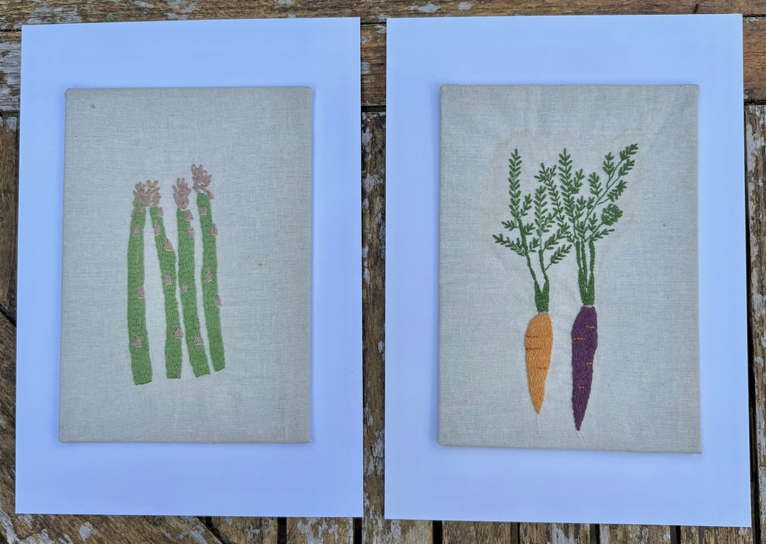 Hand embroidered asparagus and carrot companion pictures.