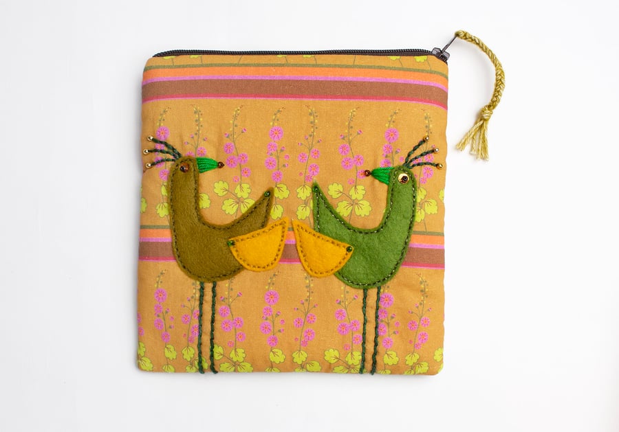 Tan hollyhock print make up bag with two applique birds
