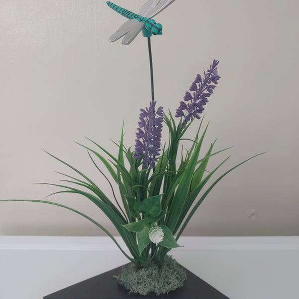 Dragonfly flower arrangement display on wood plinth