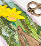 Upcycled embroidered spring rabbit and daffodil home decoration.