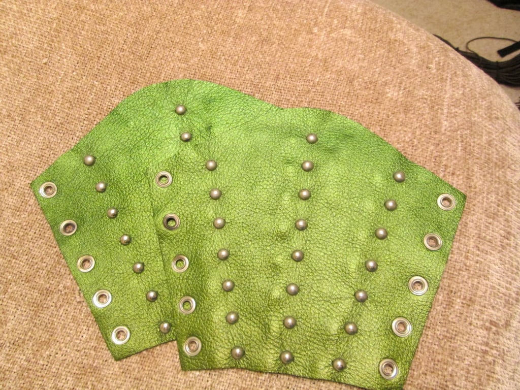 Large Pair of metallic green leather bracers with 3 rows of nickel plated spots