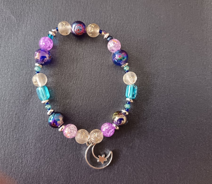 Elasticated beaded bracelet with moon charn 