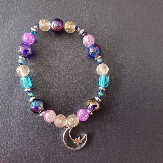 Elasticated beaded bracelet with moon charn 