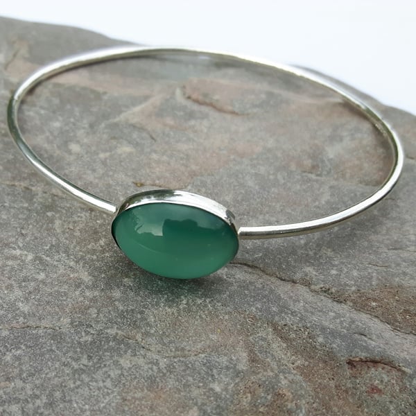 Silver bangle with turquoise cat's eye cabochon