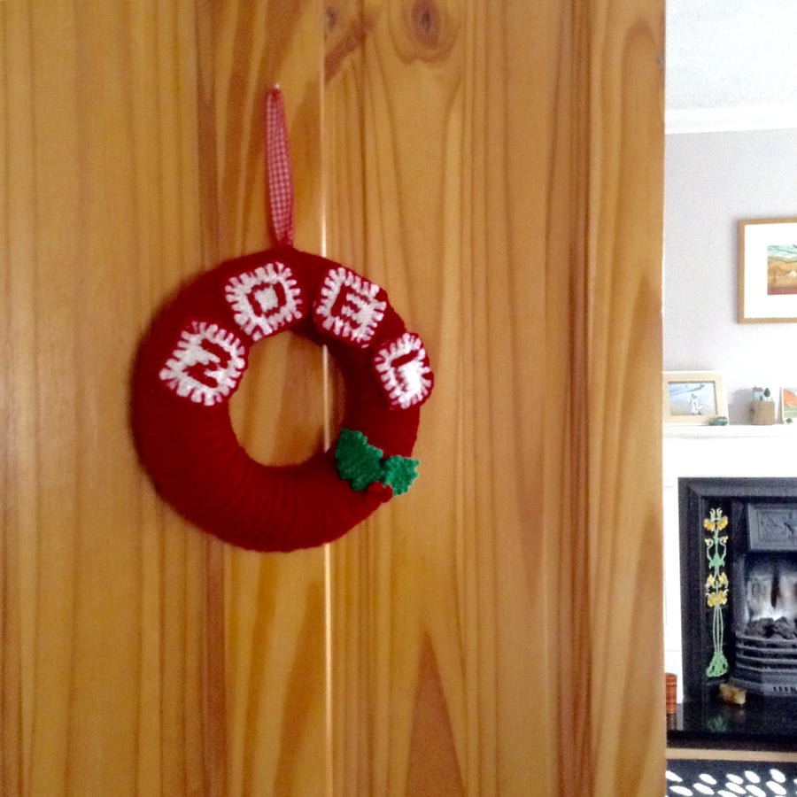 Simple wool Christmas wreath with knitted holly decoration