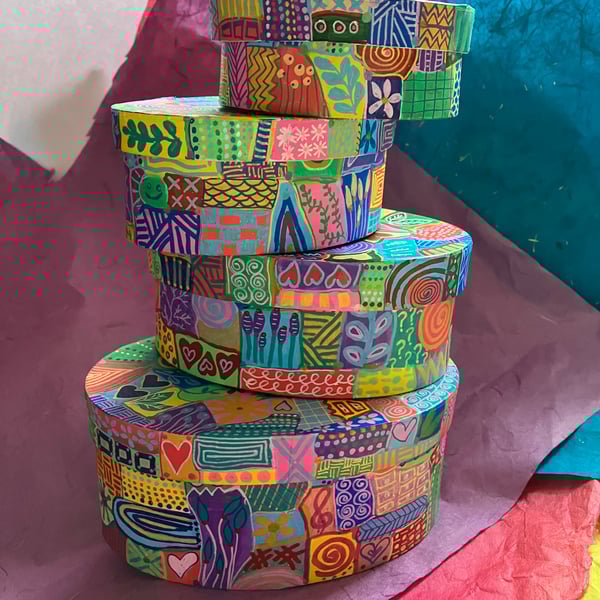 Set of 4 oval, hand painted gift boxes