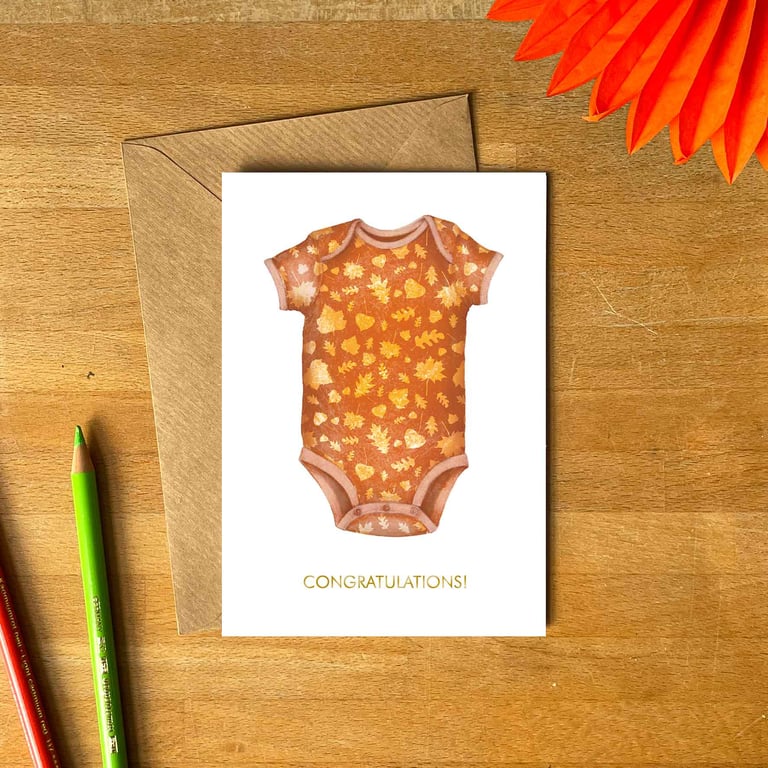 New Baby Greetings Card – Autumn Orange Romper with Falling Leaves