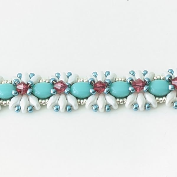 Blue and white beaded bracelet with pink crystals