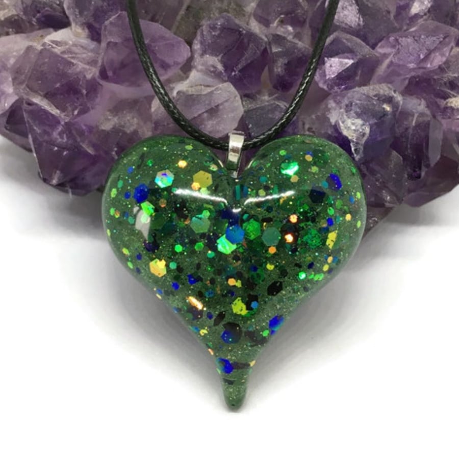 Green jewel glitter heart pendant with black cord chain necklace.