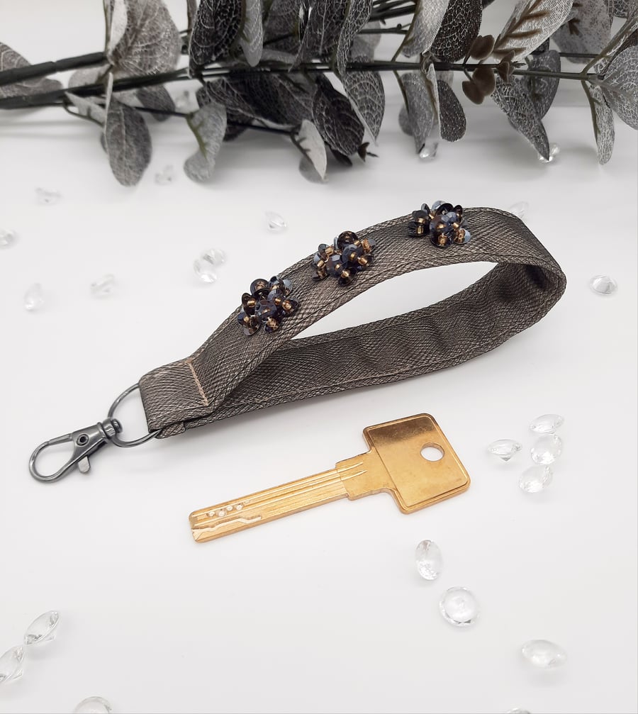 Keyring wristlet, sequin flowers, black and gold keyfob. 