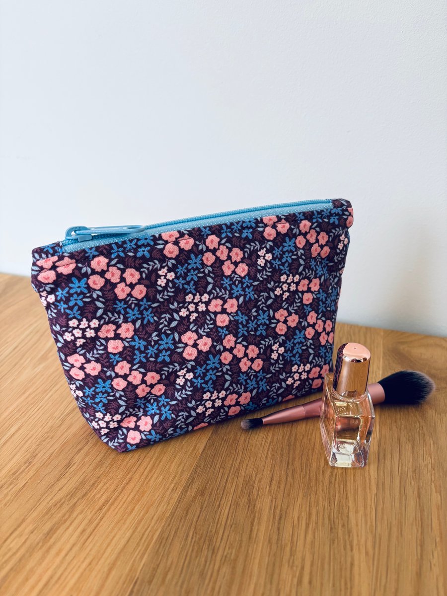 Small cotton makeup bag, pouch, purse, in purple, pink & blue floral design.