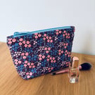 Small cotton makeup bag, pouch, purse, in purple, pink & blue floral design.