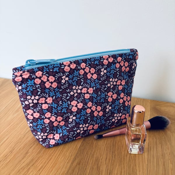 Small cotton makeup bag, pouch, purse, in purple, pink & blue floral design.