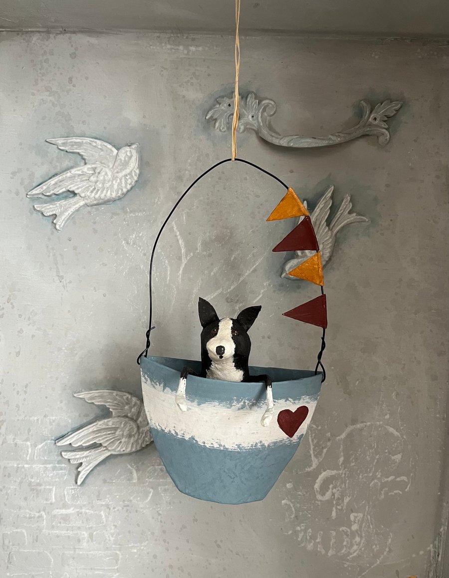 Paper mache collie dog in a hanging boat