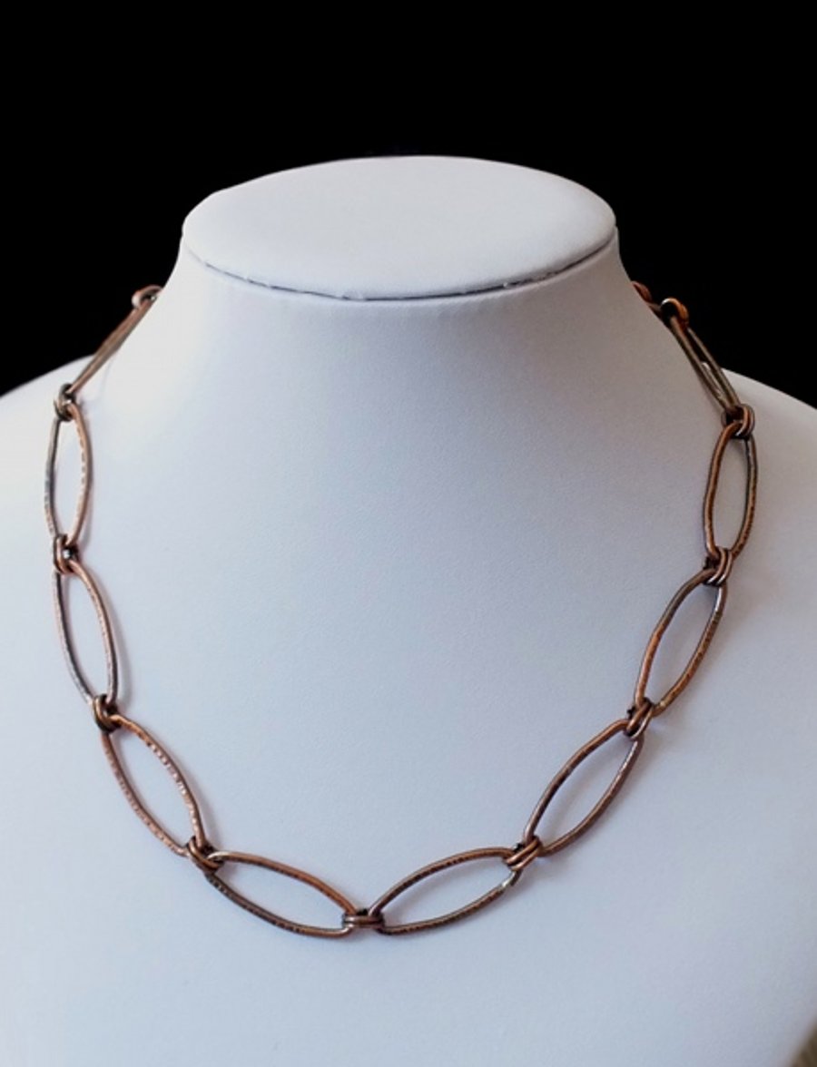 Copper chain necklace with textured oval links.