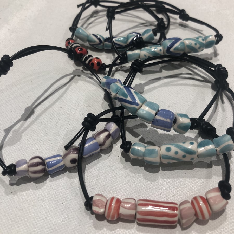 Hand-made and painted ceramic beads on leather thong