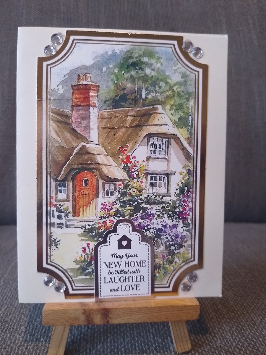 A new home card, showing a thatched cottage 