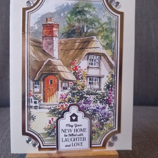 A new home card, showing a thatched cottage 