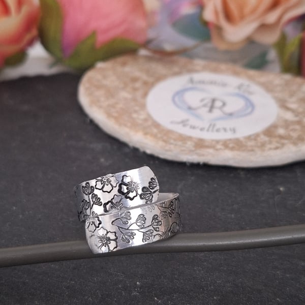 Adjustable wrap ring with a handstamped floral pattern