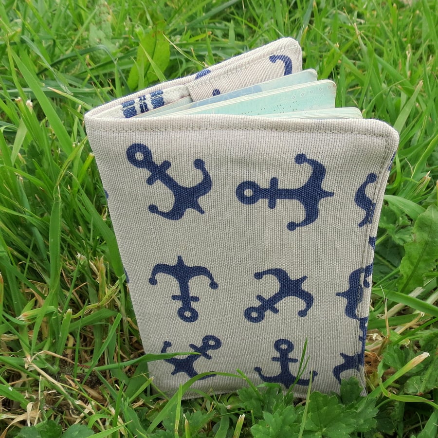 A passport cover with a nautical design.  Passport sleeve.