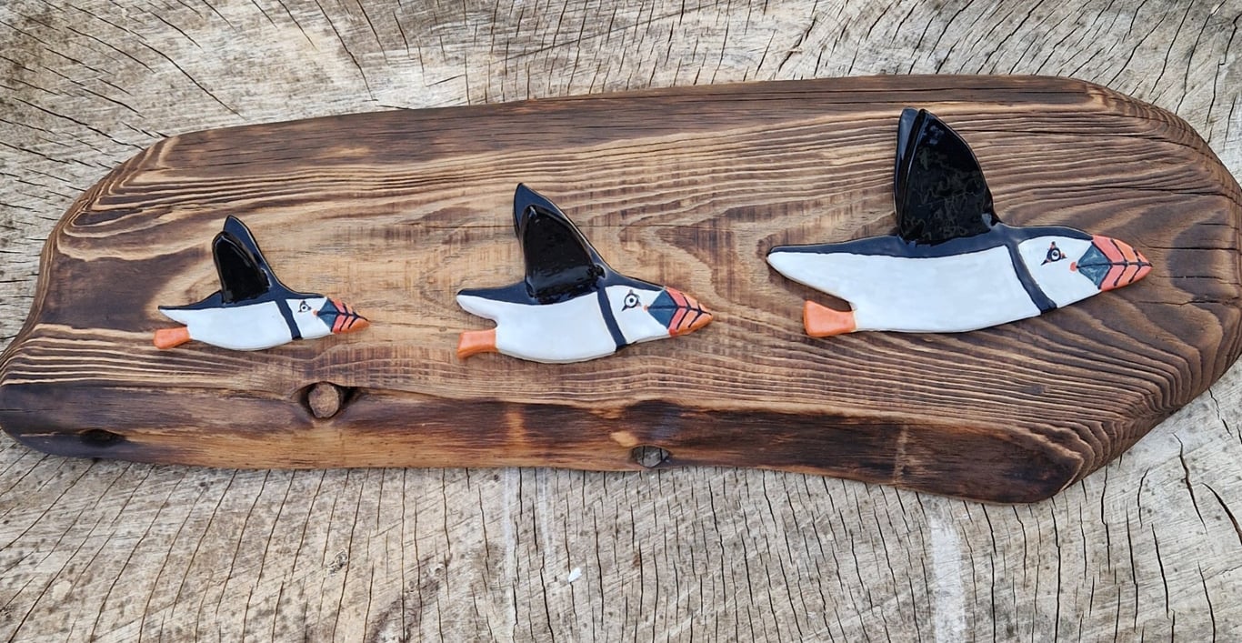 Ceramic puffin family on larch wood
