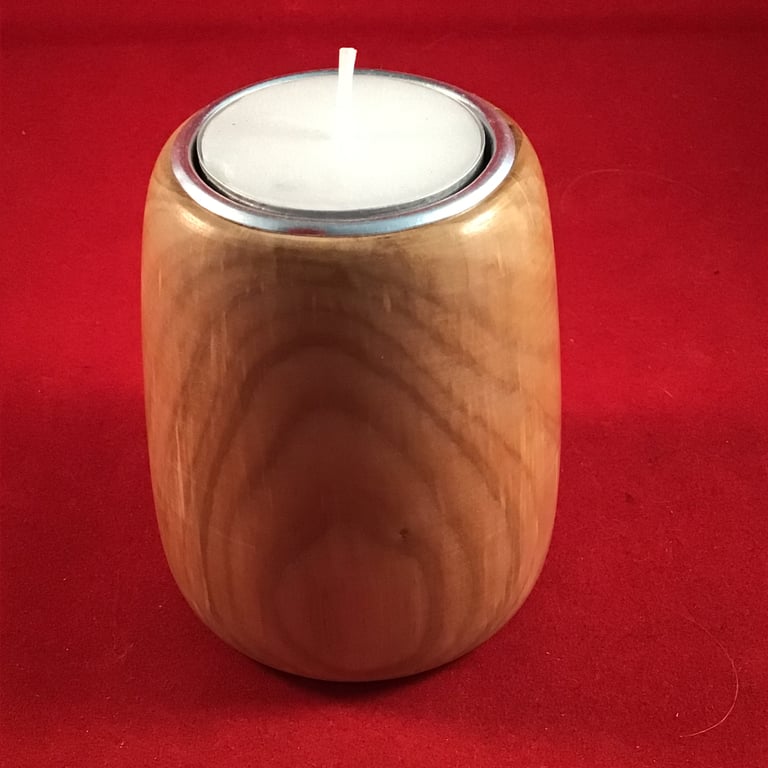 Shaped wooden tea light holder.