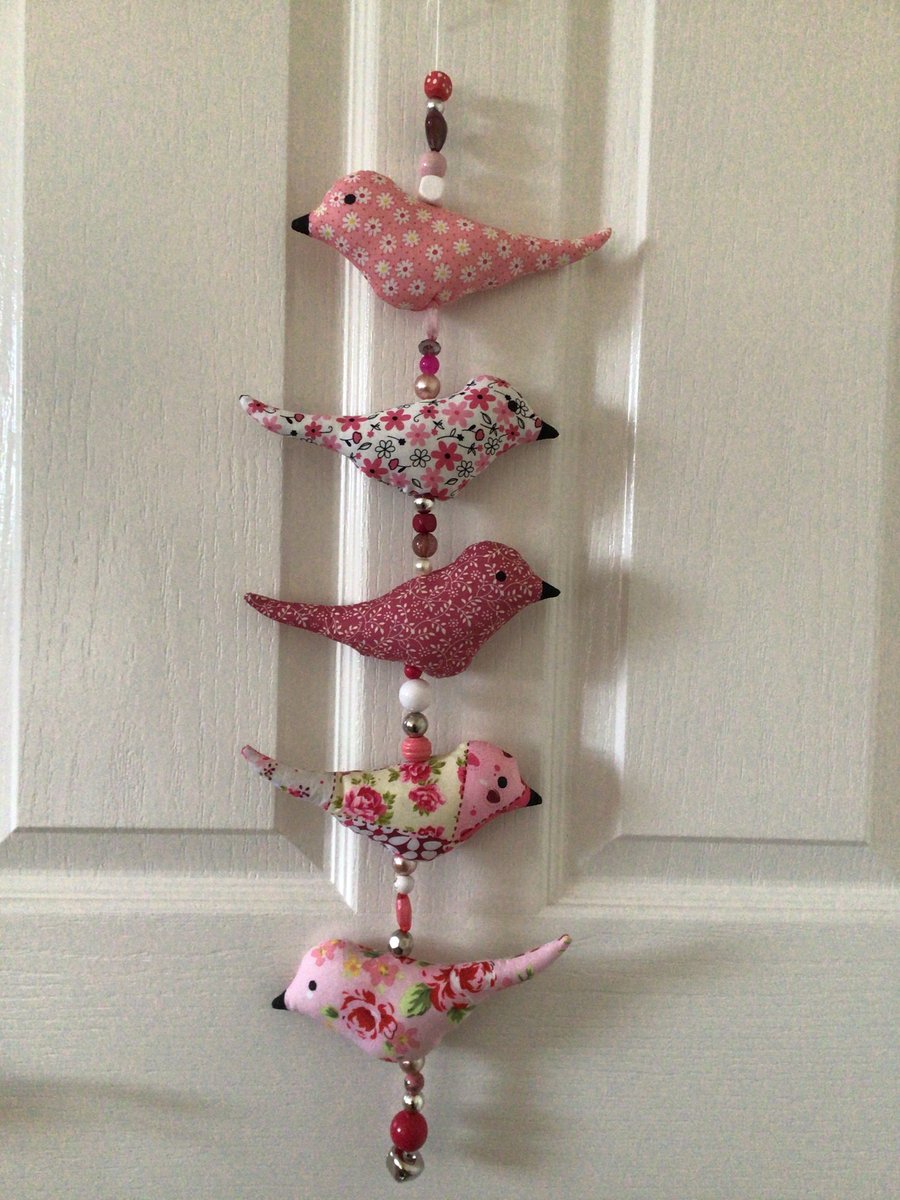 Bird hanging, pinks.