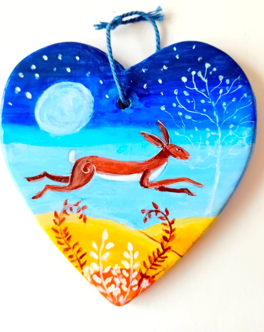 leaping moonlit hare on  a ceramic heart