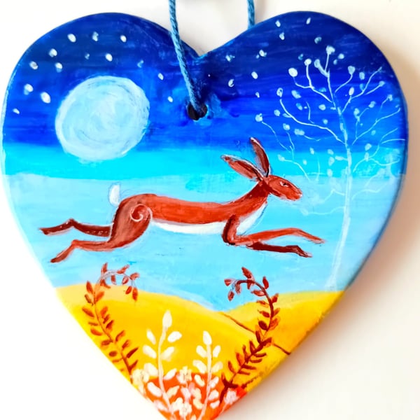 leaping moonlit hare on  a ceramic heart