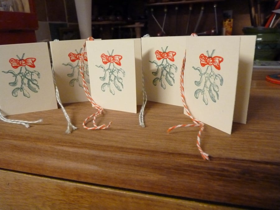 Set of 5 hand printed folding linocut gift tags. Mistletoe and bow