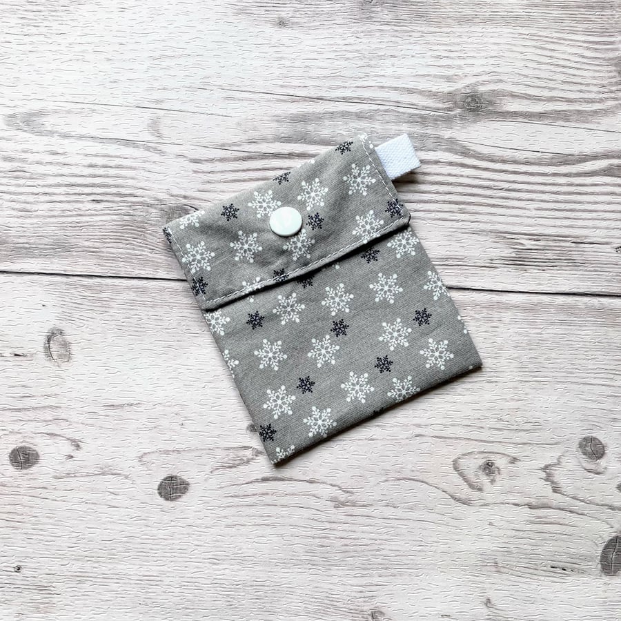 Snowflake Christmas themed silver cotton fabric gift bags with snap closure. 