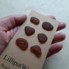 A set of six brown sea glass buttons
