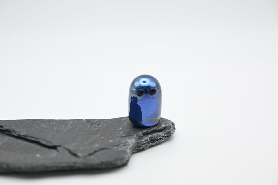 small metallic blue glass ghost