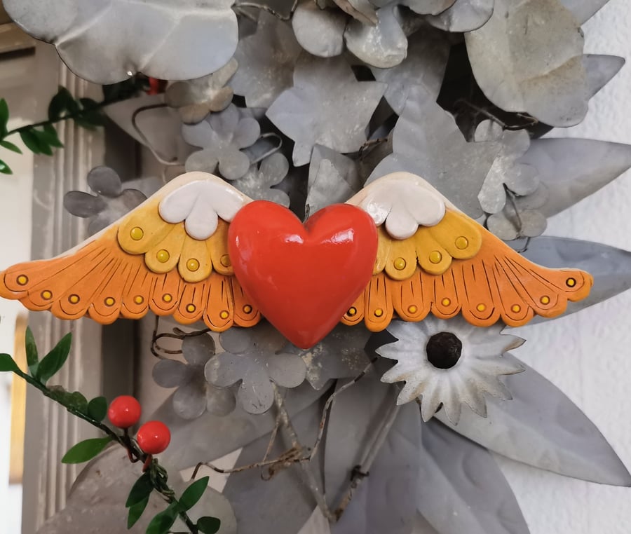 Ceramic winged heart wall art with red glazed heart white yellow orange feathers