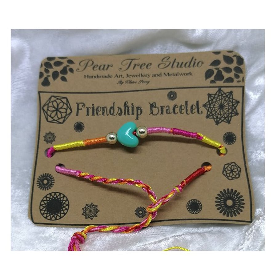 Friendship bracelet with pale blue heart bead.