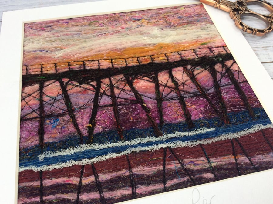 Embroidered needle felted sunset seascape with pier. 